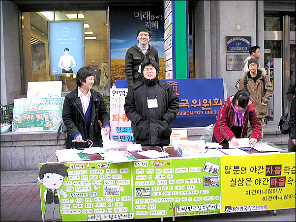 명동 유네스코회관 앞에서 서명받을 부스 준비를 마치고 기뻐하는 청소년의회 의원들 